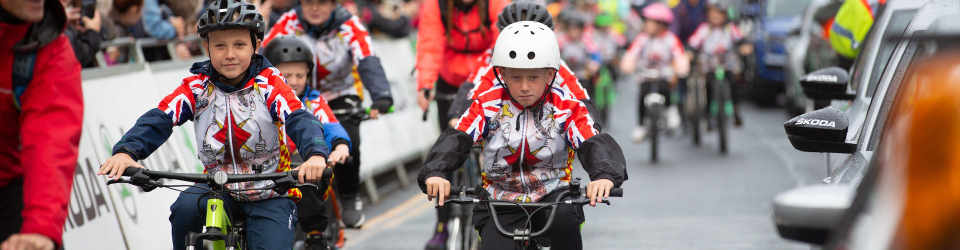 School children cycle their bikes along the streets as part of the Tour of Britain.
